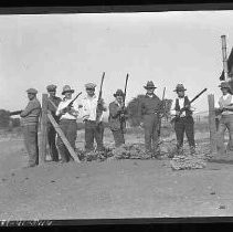 A hunting club posed with guns