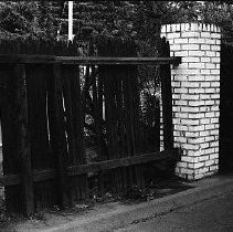 Broken fence with brick pillar