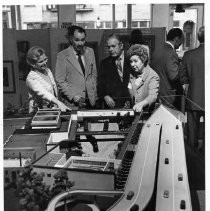 Irene Simpson Neasham and Aubrey Neasham looking at a large model, perhaps in Old Sacramento