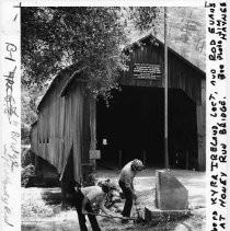 View of California Conservation Corps crew members Kyra Ireland (l) and Rod Evans (r) clear away the undergrouth at the Honey Run Covered Bridge, an 87 year-old landmark that spans Butte Creek near Chico in Butte County