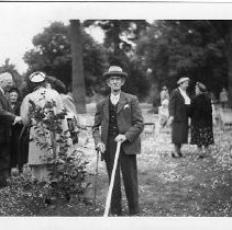 Exterior view of California State Capitol Park with Governor Earl Warren, on the far left greeting members of the Native Sons and Daughters of the Golden West in a tree planting ceremony. In the center is Len Kidder