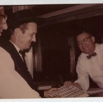 Frank S. Christy receiving the first sheet of Pony Express stamps from postal worker, Thaine Nelson