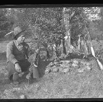 Hunter with dead partridge and rabbits