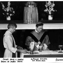 On the left, Father James T. Murphy, Pastor at St. Joseph's Parish, and Alphonse Gallego, Archbishop of Sacramento conduct holy communion