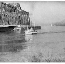 A view along the Sacramento River, fog shrouded, just below I Street Bridge