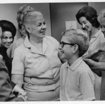 Dr. Irene Hickman, the Sacramento County Assessor, with her son Alan (13), is greeted by members of her staff after voters rejected a recall movement against her