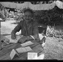 Unidentified woman seated at patio table