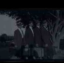 Four unidentified men with suitcases