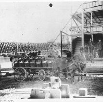 Kegs of beer from the City Brewery being delivered to an unidentified steamboat docked near the original I Street Bridge, ca.1900