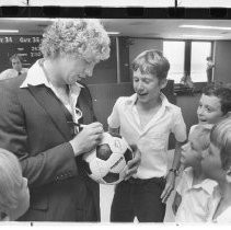 Ian Filby, soccer star signs autographs for fans at the airport