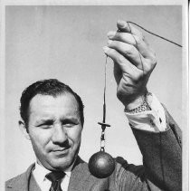 Dr. Alvin Marks, pilot and owner of Skymark Airlines. Here, Marks shows the lead-weighted end of his 150-foot radio antenna