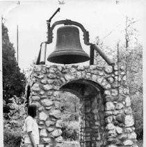 Patti Day of Woodland looks up at a bell atop a monument in Forresthill, Placer County