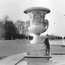 A soldier standing next to a large jardinier