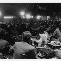 Presidential candidate Eugene McCarthy speaks to a large group of people in a hotel ballroom