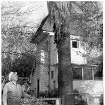 Merle Clipp stands near the tank house in Grimes