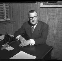 A man seated at a desk