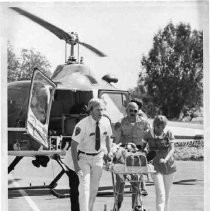 Injured man being wheeled away from California Highway Patrol rescue helicopter