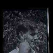 Photographic study of a young man shaving outdoors