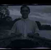 Young man with oars in a rowboat