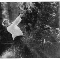 Bob Lunn, pro golfer, drives a long shot from the fairway