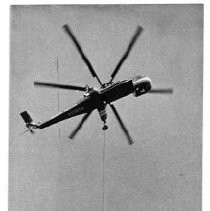 Helicopter lifting a crane section during construction of building at 555 Capitol Mall