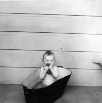 Unknown child in tub outdoors