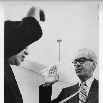 Richard Marriott takes the oath of office from Justice Leonard Friedman for his position on a state board as his wife Gerry looks on