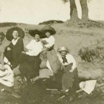 Girls with hats riding a broomstick