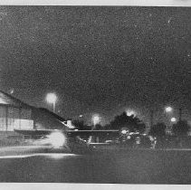 Dr. Alvin Marks, pilot and owner of Skymark Airlines. Here, his plane at night at the airport