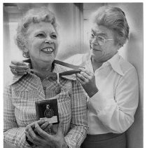 Vivian Fleming (left) honored by the Sacramento area Red Cross Chapter as the outstanding volunteer serving military, their families and veterans. Jean Hendrix (1974 recipient of the award) placed the metal around her neck