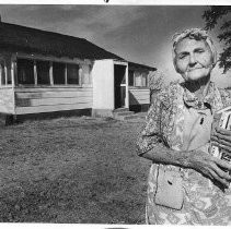Librarian, Lulu Fleming shown standing in front of her home, which is the branch library in Wilton
