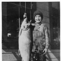 Photographs from Wild Legacy Book. Photograph, small boy holding large fish caught at Homewood, Lake Tahoe, Spring 1926