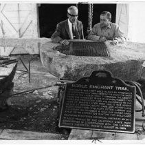 View of the plaque for the Noble Emigrant Trail in Susanville, California State Landmark #677 Lassen County. This view shows the plaque before installation as seen by James A. Pardee on the left and William Pratt on the right