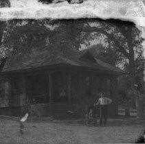 View of a man and child in front of their home in Fair Oaks