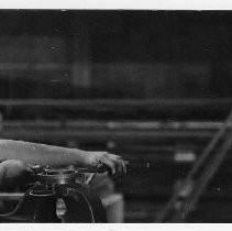 Gilbert Lopez forms a piece of ornamental scrollwork as his father Joseph Lopez watches