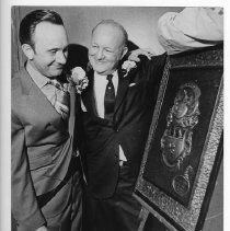 Sacramento City Councilman James G. Fuller, left is shown his family coat of arms. He was chosen Irishman of the Year for 1970