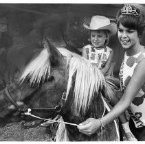 Pat Derby, Maid of Sacramento County who presides over the Sacramento County Fair gets Kim Russi to ride a horse