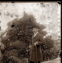 A worker on the Buffum Ranch poses for his portrait. He leans on a rifle