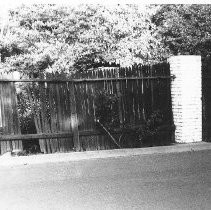 Broken fence with brick pillars