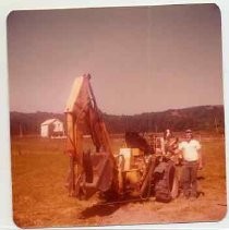 Photographs of Bolinas Bay. Tractor with backhoe, man, dog