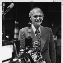 William Harrah, Nevada gaming pioneer, owner of Harrah's Hotels/Casinos, and vintage automobile collector, shown with slot machines