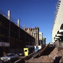 Site of the Downtown Plaza Parking Garage, Lot "G" near Macy's Department Store, 4th, 5th K and L Streets under construction. This view is looking east from the Fratt Building in Old Sacramento