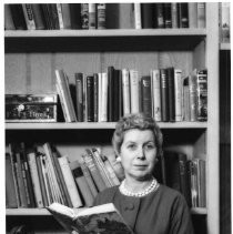 Irene Simpson Neasham, in front of bookshelves