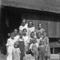 Children with a crate of plums