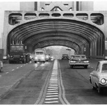 Tower Bridge;Increased traffic flow: The railroad tracks down the center of the Tower Bridge have been removed so the bridge deck now handles a full four lanes of automobile and truck traffic