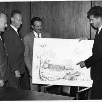 Developers and architects presenting architectural drawing of Brown-McKeon Building