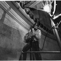 Dr. John Asmus demonstrates how a laser is used to remove various layers of paint from the walls of the California State Capitol building revealing the murals beneath the layers