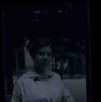 A woman with one hand on a fence