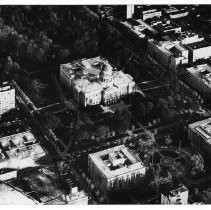 Aerial view of the California State Capitol building looking east from about 9th Street. In the foreground is State Office Building 1 and the State Library on the circle