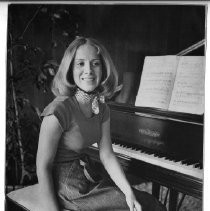 Tierney Lambert, seated at the piano